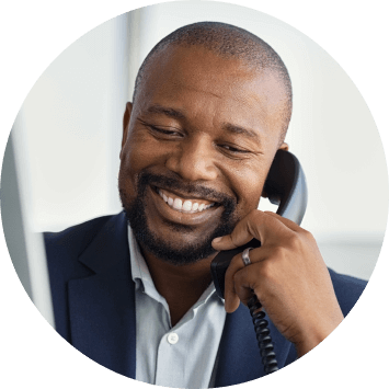 A male business professional talking on the phone