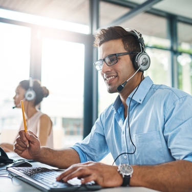 Man in blue shirt wearing headphones