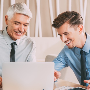 Professionals discussing with laptop