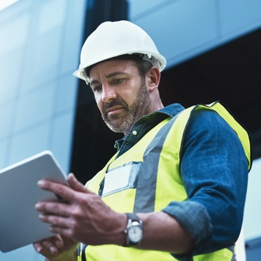 Engineer looking into ipad at construction site