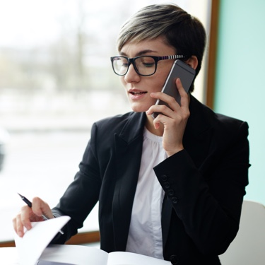 Professional woman in black suit reading documents